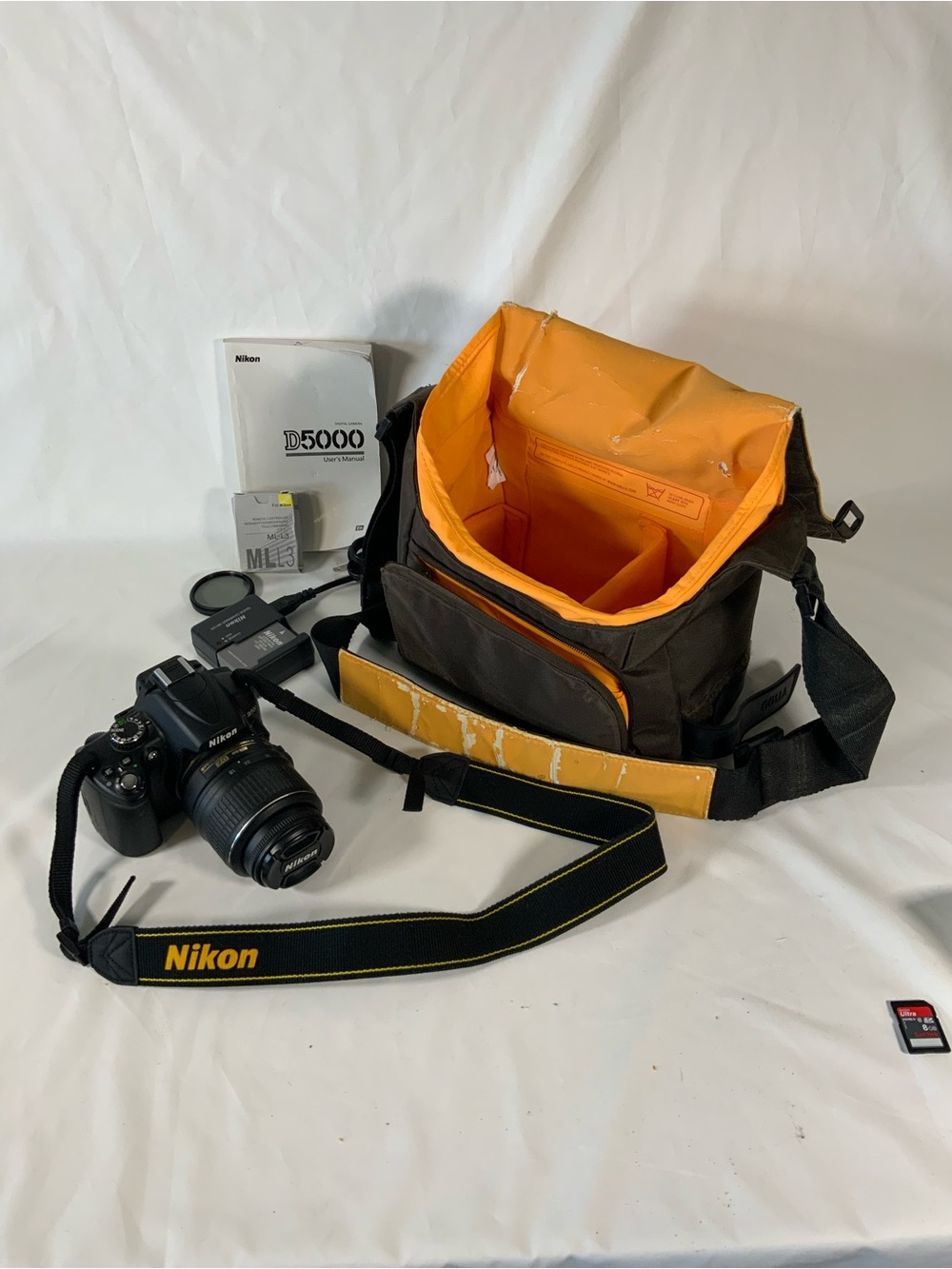 Nikon DSLR Camera with Black Body and Yellow-Orange Interior Bag